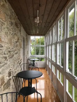 a room with tables and chairs and windows at Casa De Don Lino in Lugo