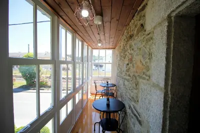 a row of tables in a room with windows at Casa De Don Lino in Lugo