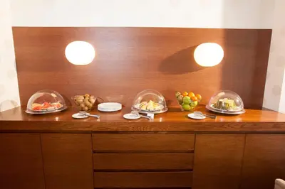 a wooden counter with bowls of fruit on it at Hotel Spa Attica21 Vilalba in Villalba