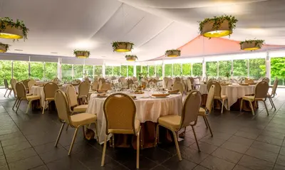 a banquet hall with tables and chairs in a tent at Hotel Spa Attica21 Vilalba in Villalba