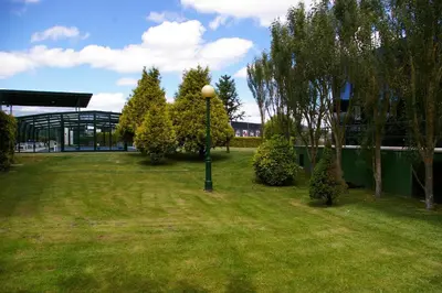 a park with a light pole in the grass at Hotel Auditorio Santiago & Spa in Lugo