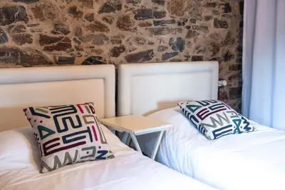 two beds sitting next to each other in a room at Houmi As Bouzas in Castrelo de Miño