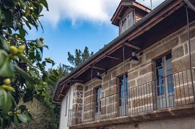 an old building with windows and a balcony at Houmi As Bouzas in Castrelo de Miño