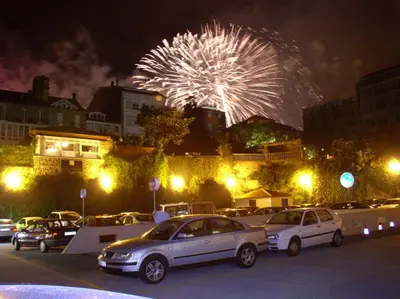 a group of cars parked in a parking lot with fireworks at Hotel Parking Miradoiro de Belvís in Santiago de Compostela