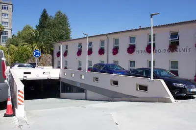 a parking lot with cars parked on top of a building at Hotel Parking Miradoiro de Belvís in Santiago de Compostela
