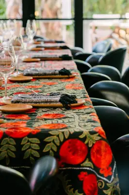a row of tables with plates and wine glasses at Casa Beatnik Country House in Santiago de Compostela