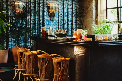 a bar with a row of chairs in a restaurant at Casa Beatnik Country House in Santiago de Compostela