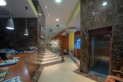 a lobby with a staircase with stone walls at Aparthotel Arenteiro in Carballino