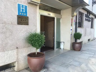 two potted trees sitting outside of a hotel at Hotel San Lorenzo in Santiago de Compostela