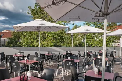 a bunch of tables and umbrellas on a patio at Hotel San Lorenzo in Santiago de Compostela