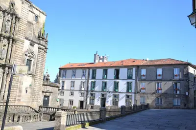 a large white building with a red roof at Pensión Da Estrela in Santiago de Compostela