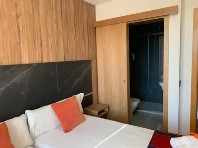 a bedroom with a bed and a bathroom with a tub at Pensión Da Estrela in Santiago de Compostela