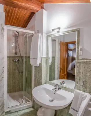 a bathroom with a sink and a shower at Hotel Herradura in Santiago de Compostela