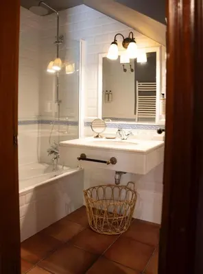 a bathroom with a sink and a tub and a mirror at SNÖ Pazo de Adrán in Milladoiro