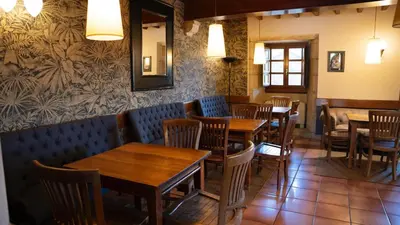 a restaurant with tables and chairs and a mirror at SNÖ Pazo de Adrán in Milladoiro