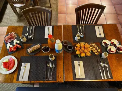 a wooden table with food and utensils on it at SNÖ Pazo de Adrán in Milladoiro