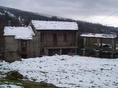 a house with snow on top of it at Casa da Laxa in Beáriz