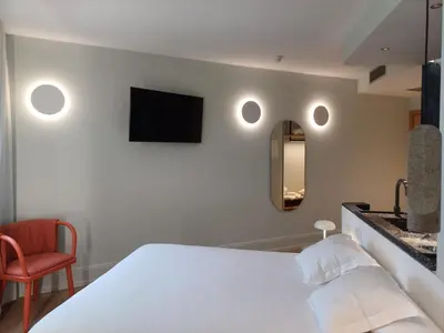 a bedroom with a white bed and a mirror at Ruta Jacobea in Lavacolla