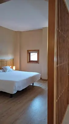 a bedroom with a large bed and a window at Ruta Jacobea in Lavacolla
