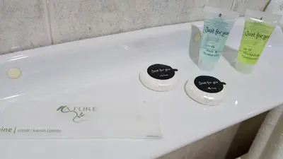 a white bathroom sink with three products on it at Motel Montecarlo in Teo