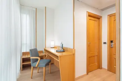 a room with a desk and a chair and a door at Exe Area Central in Santiago de Compostela