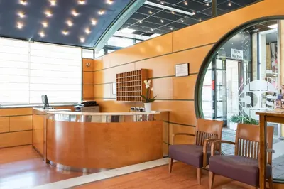 an office with a reception desk and chairs at Exe Area Central in Santiago de Compostela