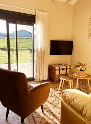 a living room with a couch and a television at El Pueblín del Pinar in Navia