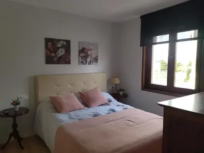 a bedroom with a bed with two pink pillows at Casanova in Fene