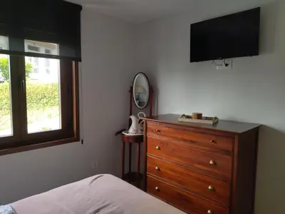 a bedroom with a dresser and a flat screen tv at Casanova in Fene