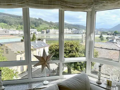 a living room with a large window with a view at The Cliffs - Passion Eccehomo in Viveiro