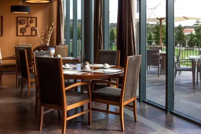 a dining room with a wooden table and chairs at Eurostars Vila de Allariz Hotel Balneario in Allariz