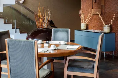 a dining room with a wooden table and chairs at Eurostars Vila de Allariz Hotel Balneario in Allariz