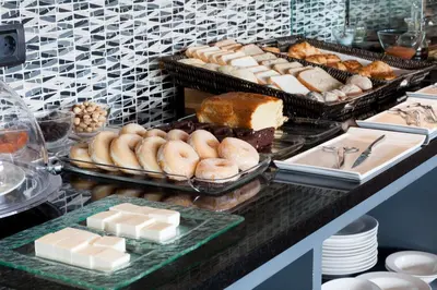 a buffet with donuts and other pastries on a counter at Eurostars Vila de Allariz Hotel Balneario in Allariz