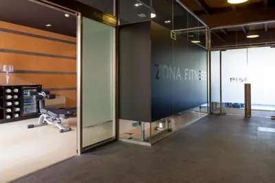 a gym with a glass wall and a treadmill at Eurostars Vila de Allariz Hotel Balneario in Allariz