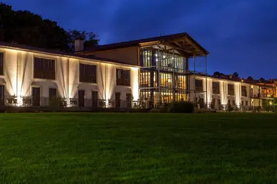 a large white building with a lawn at night at Eurostars Vila de Allariz Hotel Balneario in Allariz