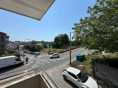 a white car parked on the side of a road at Apartamento Sta Cruz 2 Dormitorios in A Coruña