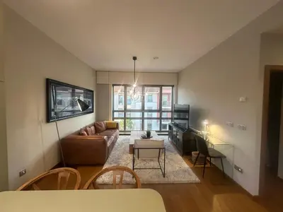a living room with a couch and a table at Apartamento Sta Cruz 2 Dormitorios in A Coruña