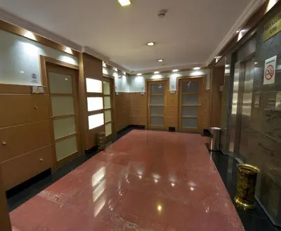 a room with a hallway with lockers and a large marble floor at Hotel Francisco II in Ourense