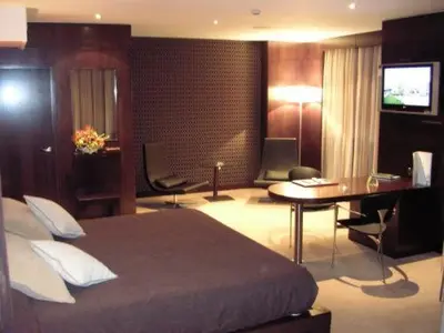 a hotel room with a bed and a desk at Hotel Francisco II in Ourense
