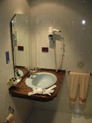 a bathroom with a sink and a phone at Hotel Francisco II in Ourense