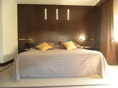 a bedroom with a large bed with brown walls at Hotel Francisco II in Ourense