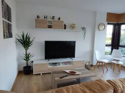 a living room with a flat screen tv at Casa Rigo en Sigüeiro, cerca de Santiago de Compostela in Sigüeiro