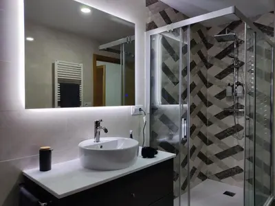 a bathroom with a sink and a shower at Casa Rigo en Sigüeiro, cerca de Santiago de Compostela in Sigüeiro