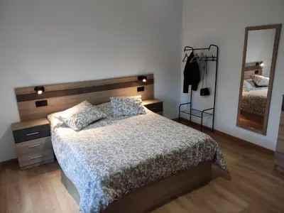 a bedroom with a bed and a large mirror at Casa Rigo en Sigüeiro, cerca de Santiago de Compostela in Sigüeiro