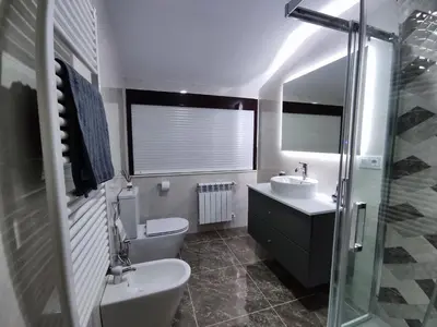 a bathroom with a sink and a toilet and a shower at Casa Rigo en Sigüeiro, cerca de Santiago de Compostela in Sigüeiro