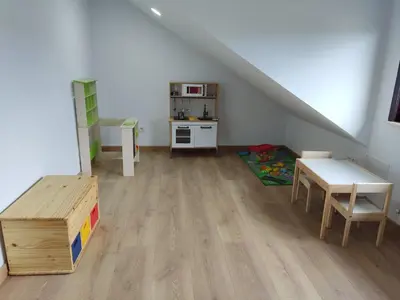 an attic room with a table and a kitchen at Casa Rigo en Sigüeiro, cerca de Santiago de Compostela in Sigüeiro