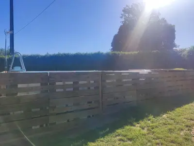 a fence in a field with the sun behind it at Casa Rigo en Sigüeiro, cerca de Santiago de Compostela in Sigüeiro
