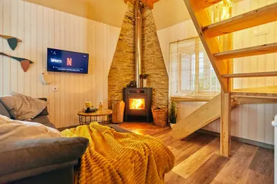 a living room with a couch and a fireplace at Casa Montse. Apartamentos turísticos in Ribadeo
