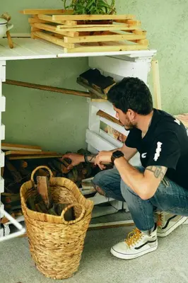 a man is sitting on a shelf in a drawer at Casa Montse. Apartamentos turísticos in Ribadeo