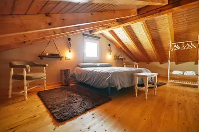 a bedroom with a bed and a table and a chair at Casa Montse. Apartamentos turísticos in Ribadeo